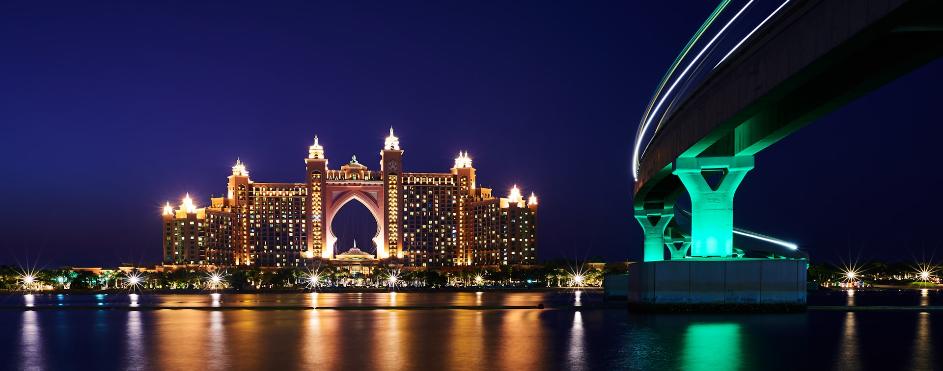 a large bridge over a body of water at night