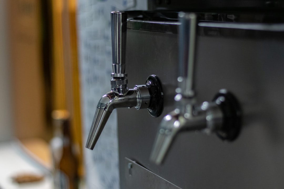 selective focus photography of gray faucets