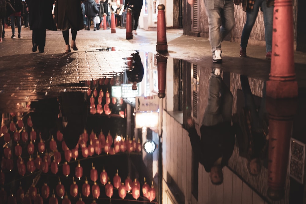 photography of walking people near outdoor during nighttime