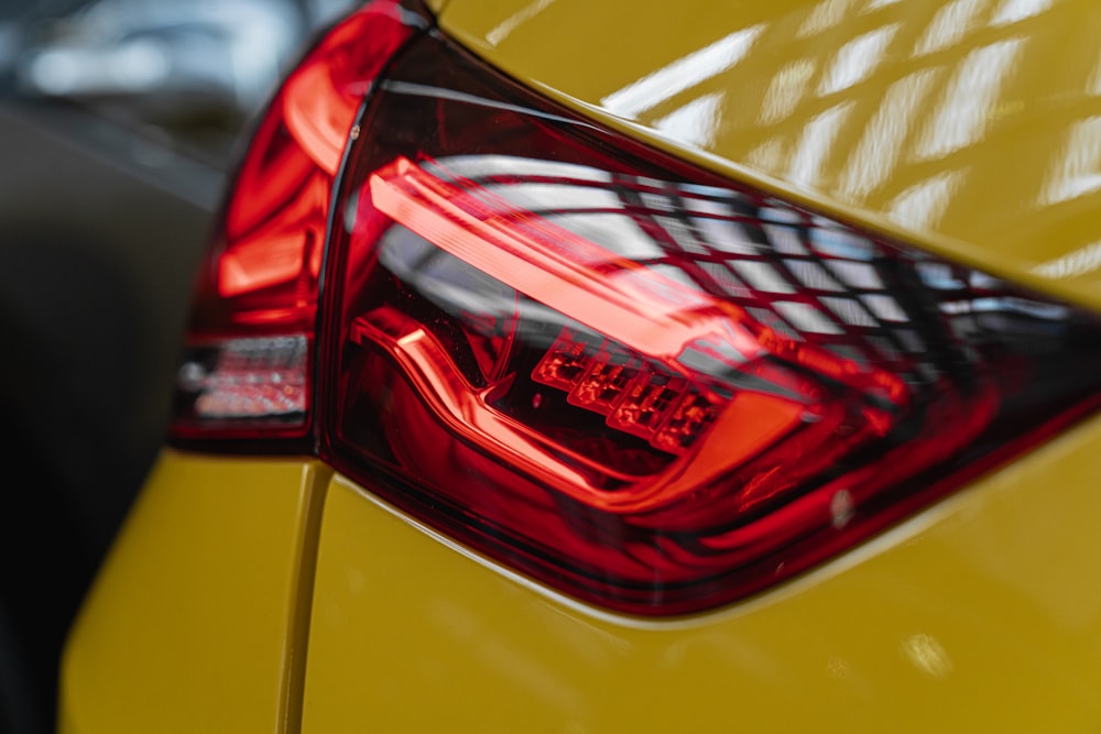 a close up of the tail light of a yellow car