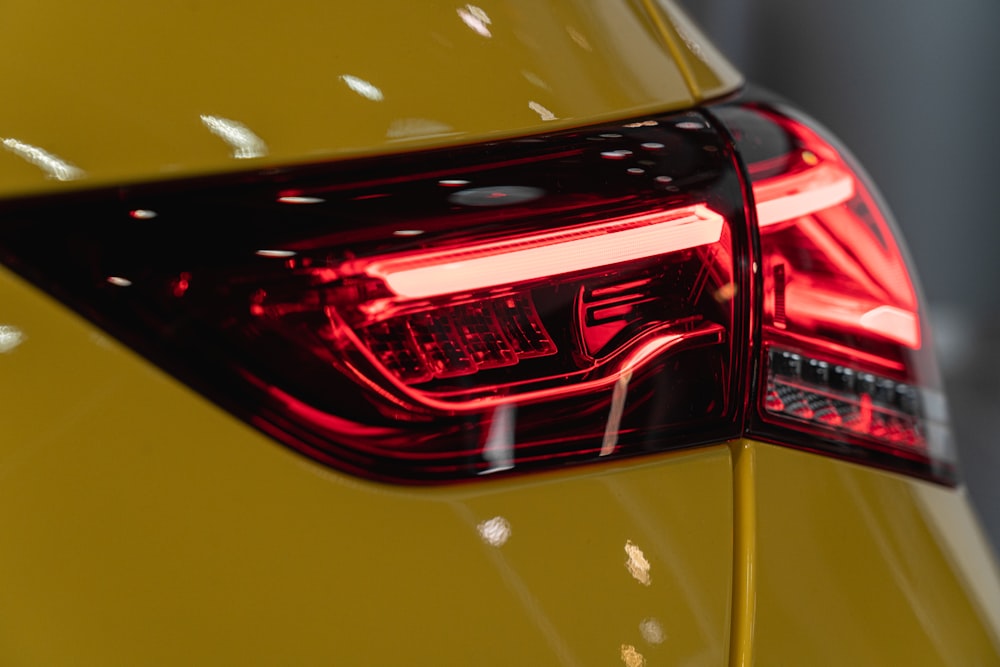 a close up of the tail light of a yellow car