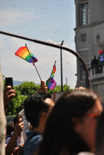 A diverse group of smiling people gathered outdoors, symbolizing community strength and support.