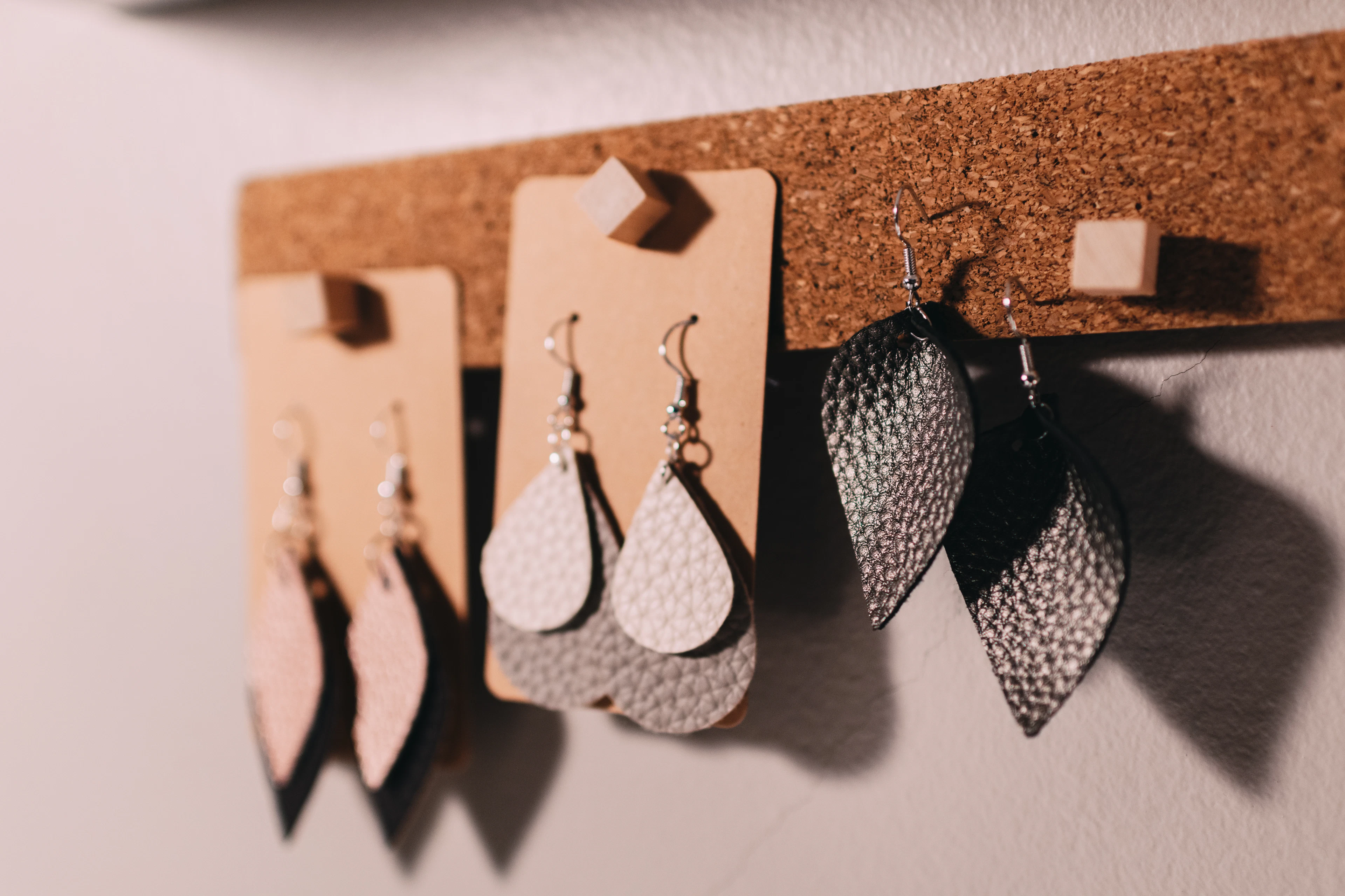 Three pairs of handmade hook earrings laid out side by side.