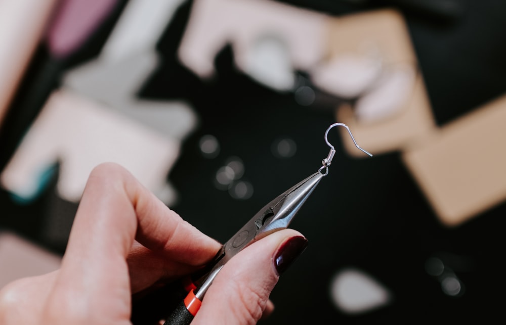 a close up of a person holding a pair of scissors