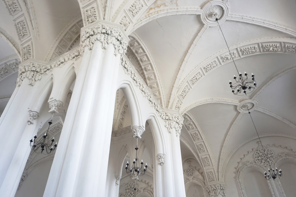 white concrete pillared building with chandeliers