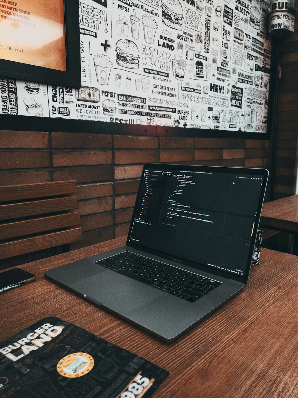 MacBook Pro on brown wooden table