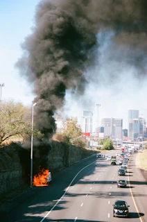 large black smoke beside lamp post on road during daytime