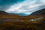 a scenic view of a valley with a river running through it