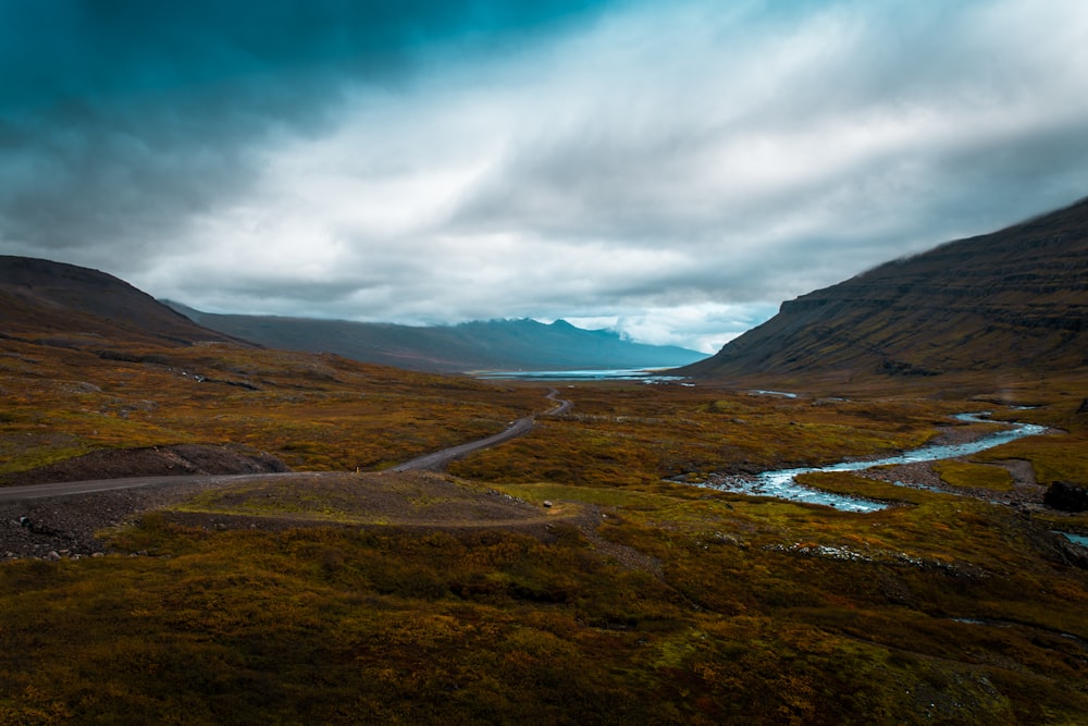 a scenic view of a valley with a river running through it