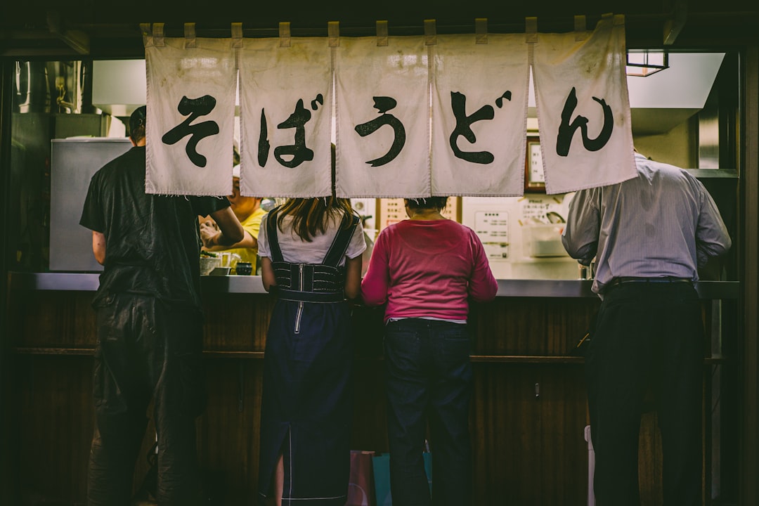 person in black T-shirt, People eating standing up at ramen restaurant in Tokyo, Japan