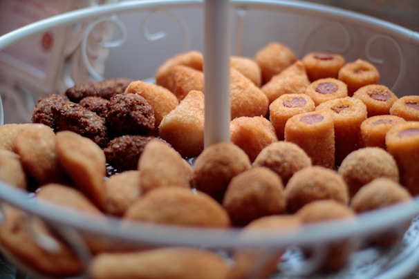 Close-up of freshly fried golden salgados on a tray