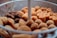A close-up view of a tray filled with various types of fried or baked snacks, including rolls with sausage filling, brown round croquettes, and other golden-brown finger foods.