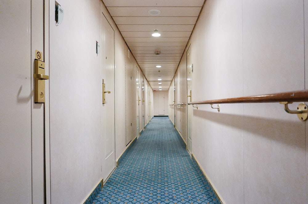 a long hallway with a blue tile floor