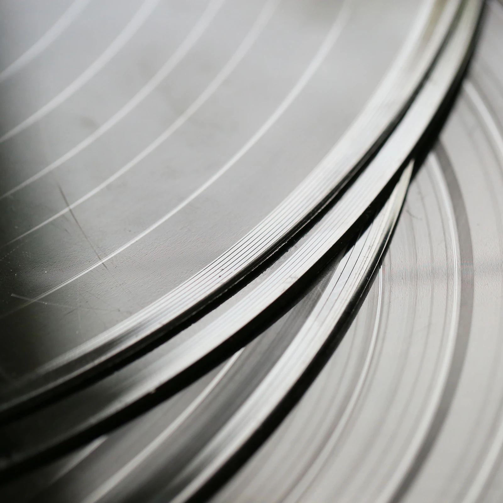 Record grooves catching light in black and white
