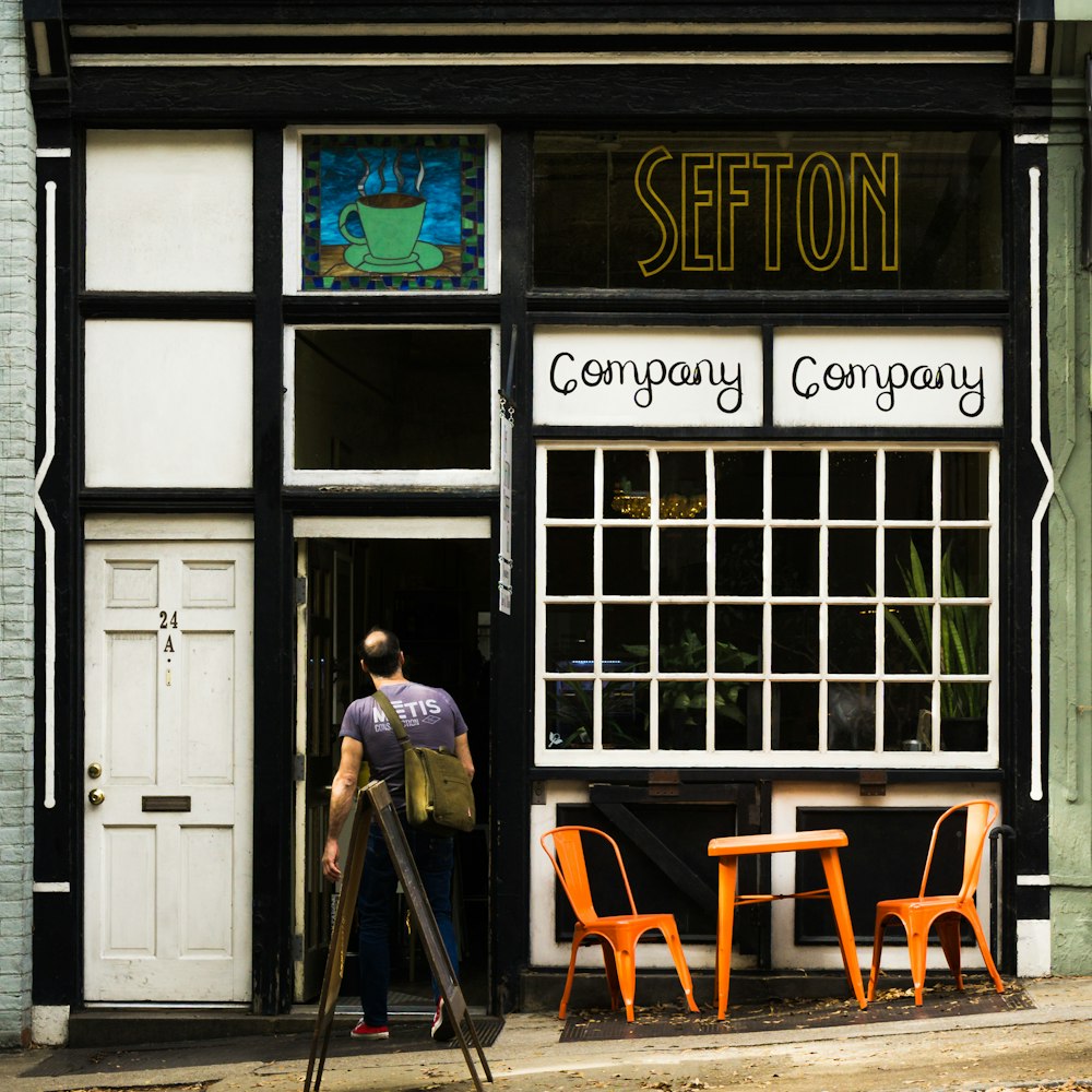 man standing in front of Sefton Company building