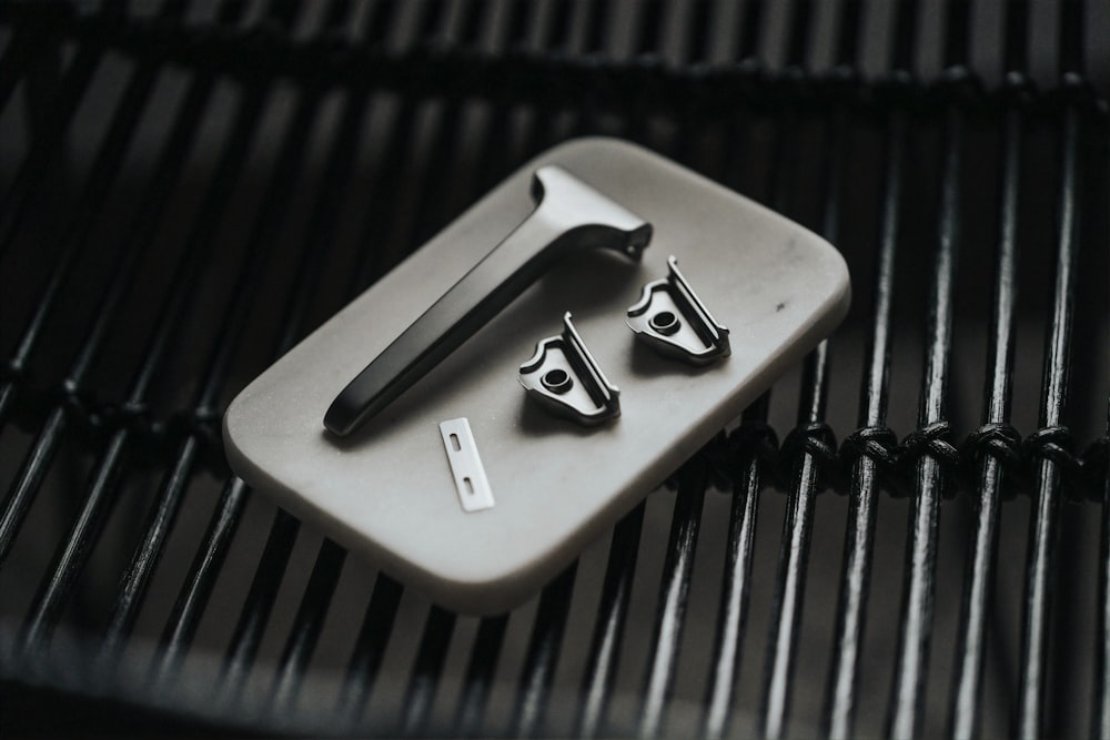 a bbq grill with tongs and tongs on it