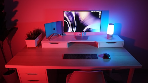 Minimalist clean tech style office desk with a laptop and a blue accent light.