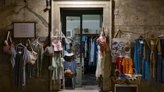 assorted clothes hanging in front of store