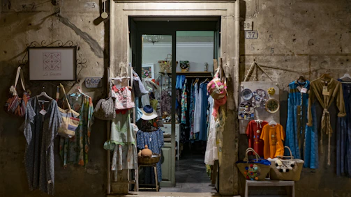 assorted clothes hanging in front of store