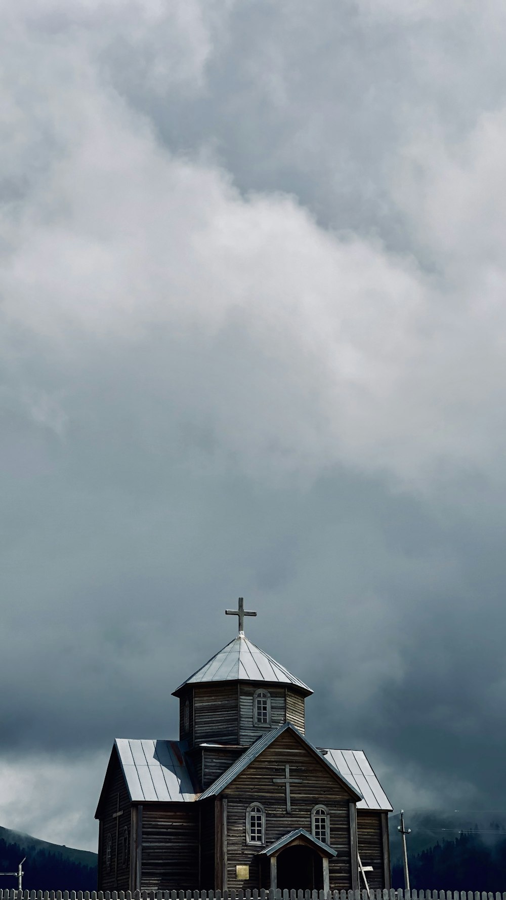 brown wooden cathedral under white clouds