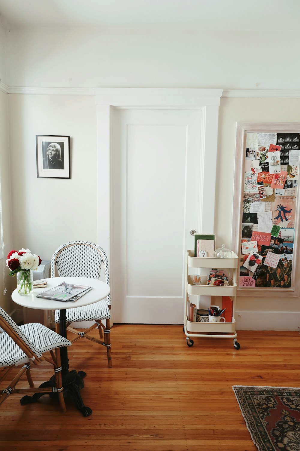 white 3-layered rack beside closed door