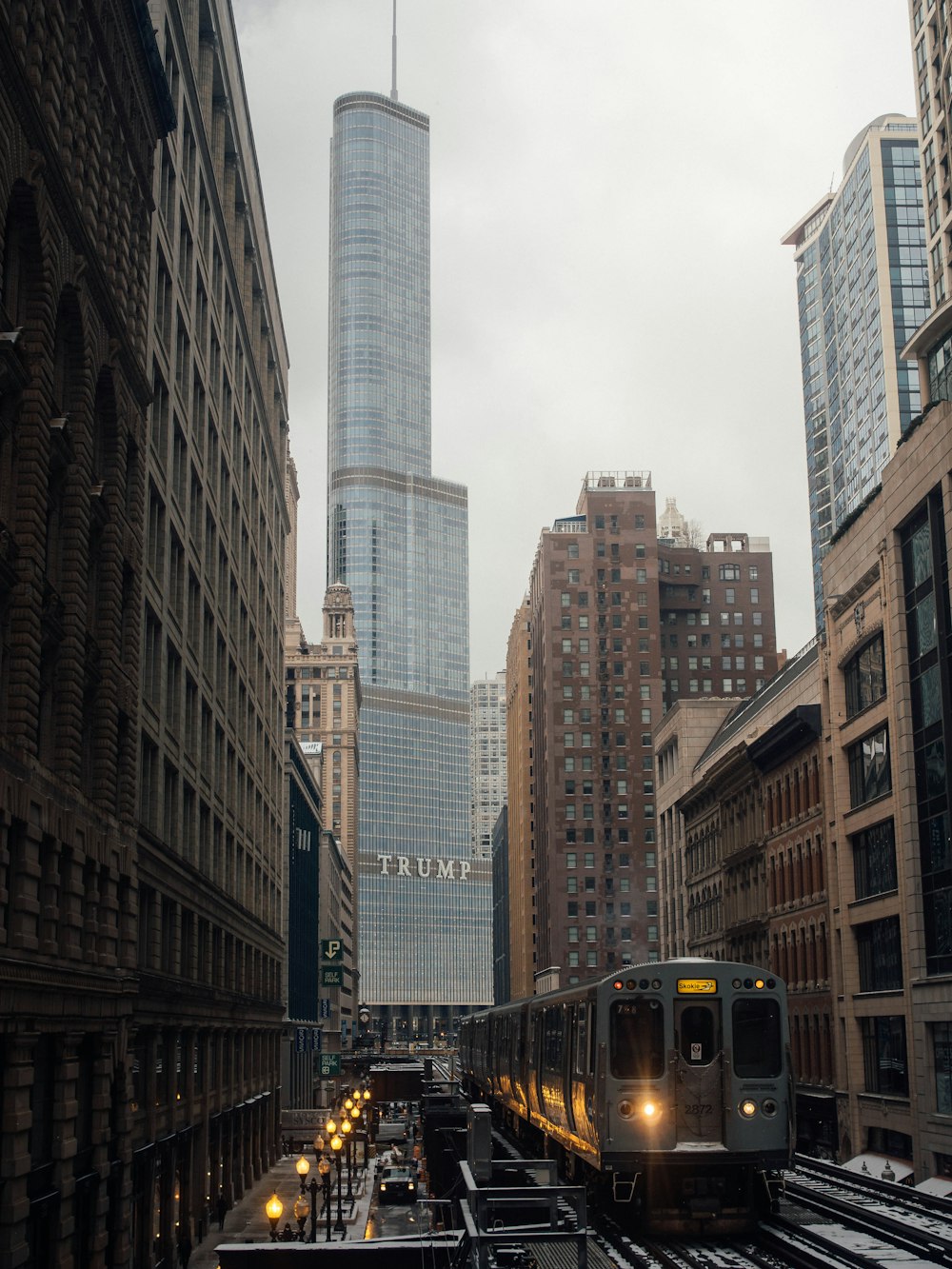 grey train beside buildings