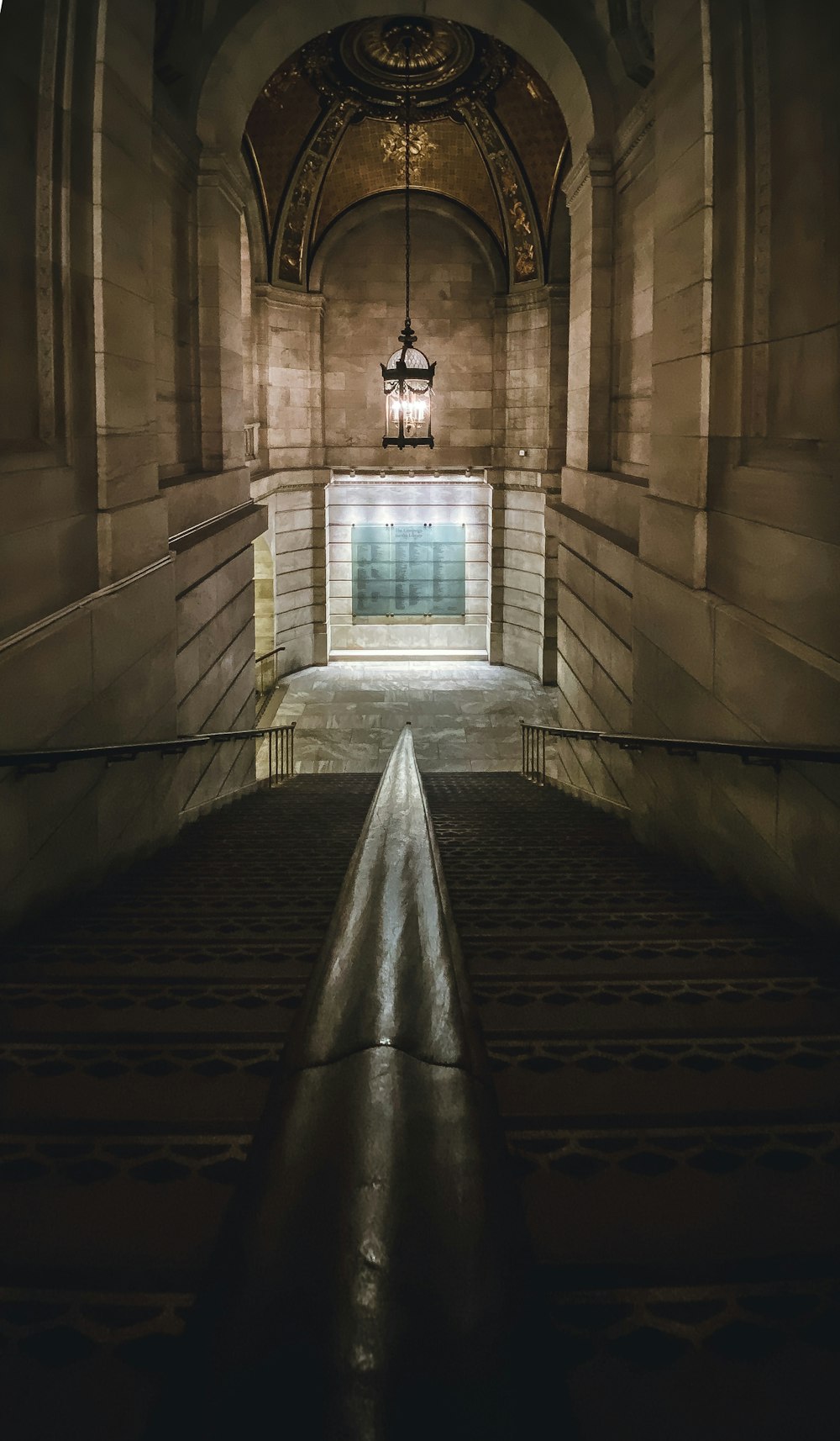 a long hallway with a light hanging from the ceiling