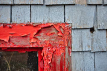 red paints on wooden frame during daytime
