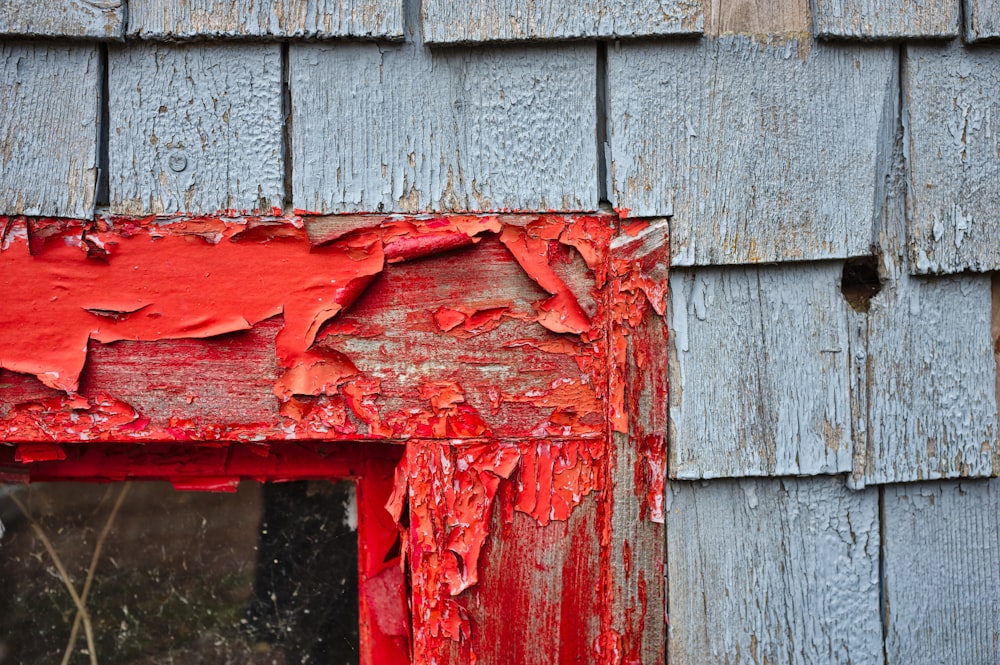 red paints on wooden frame during daytime