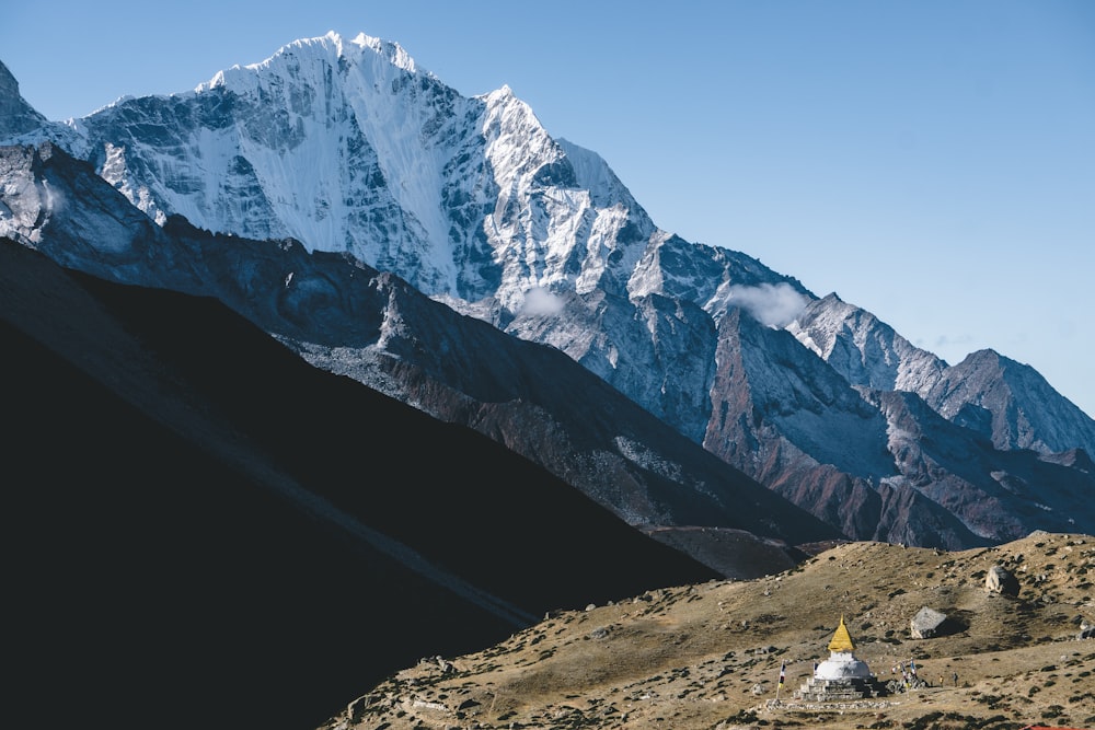 aerial photography of filed viewing mountain under blue and white sky during daytime