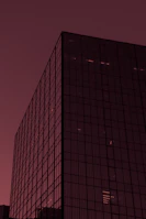 Modern Chicago high-rise with reflective windows and a hint of red in the facade.