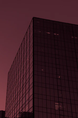 Modern Chicago high-rise with reflective windows and a hint of red in the facade.
