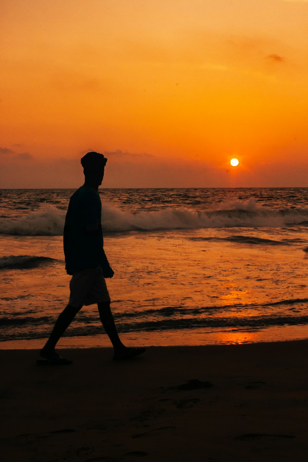 silhouette of person standing on seashore