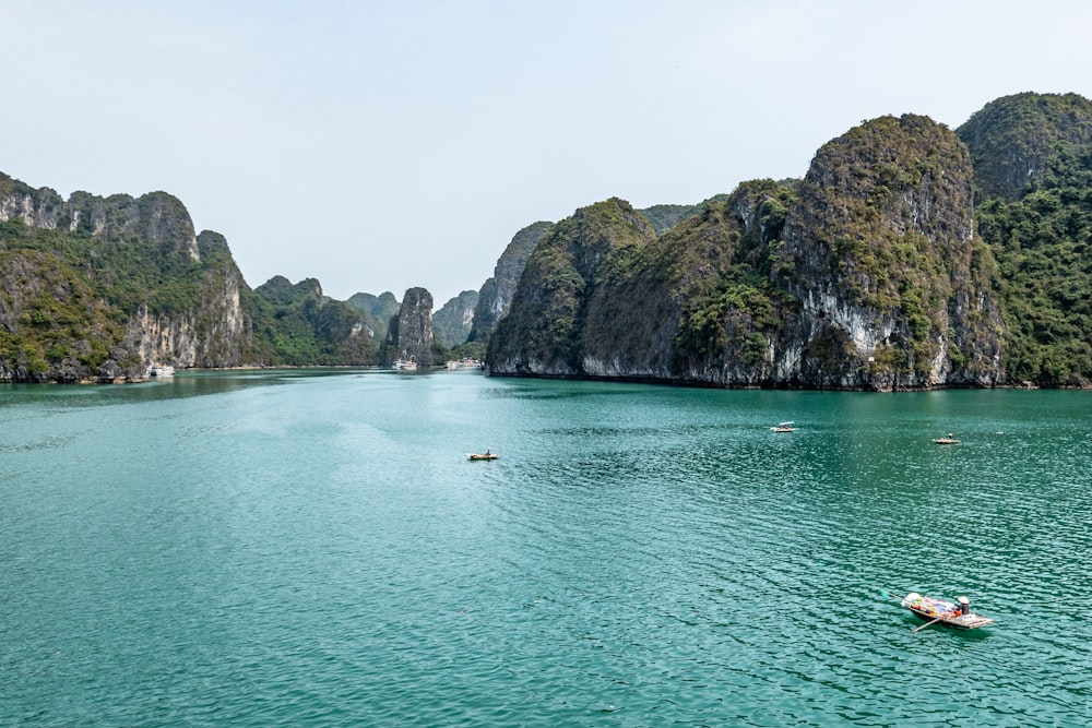 body of water near mountain during daytime