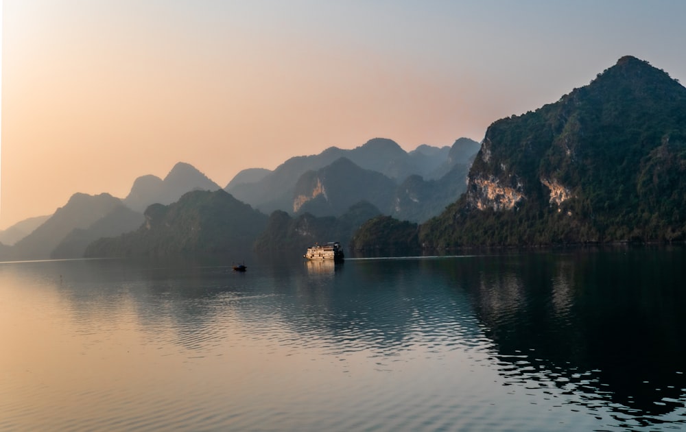 body of water near mountain during daytime