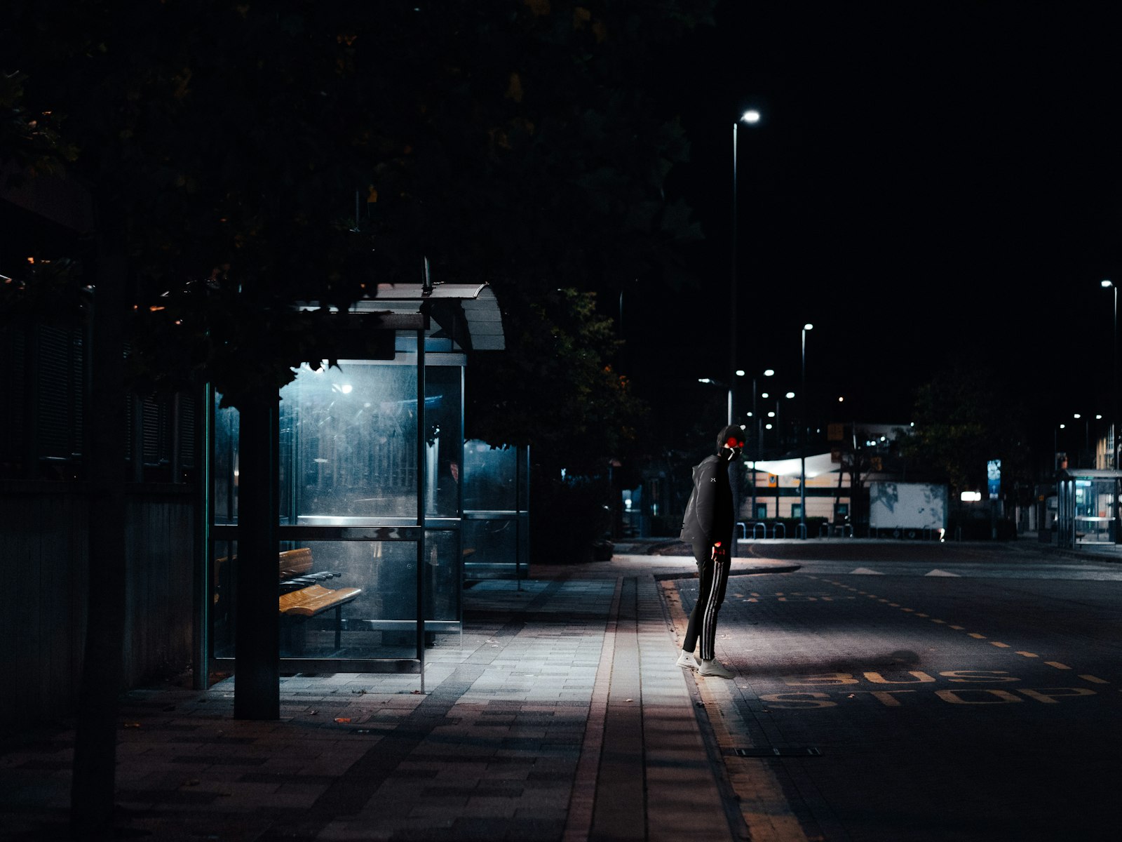 Panasonic Lumix DC-GH5 + Olympus M.Zuiko Digital 45mm F1.8 sample photo. Man standing beside road photography