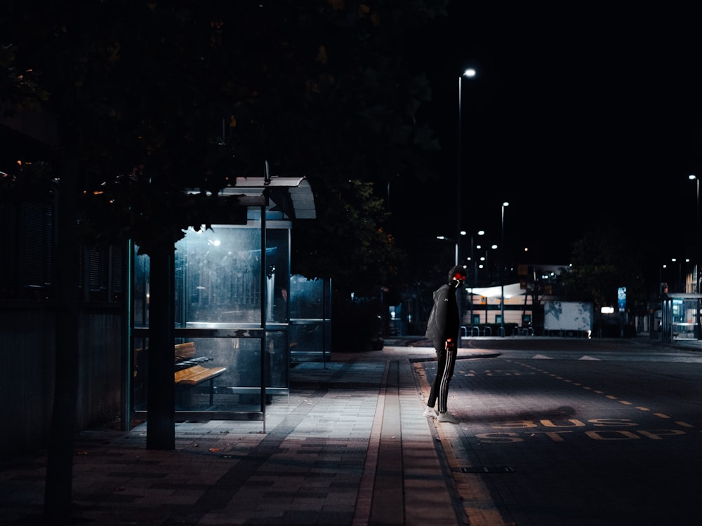 man standing beside road