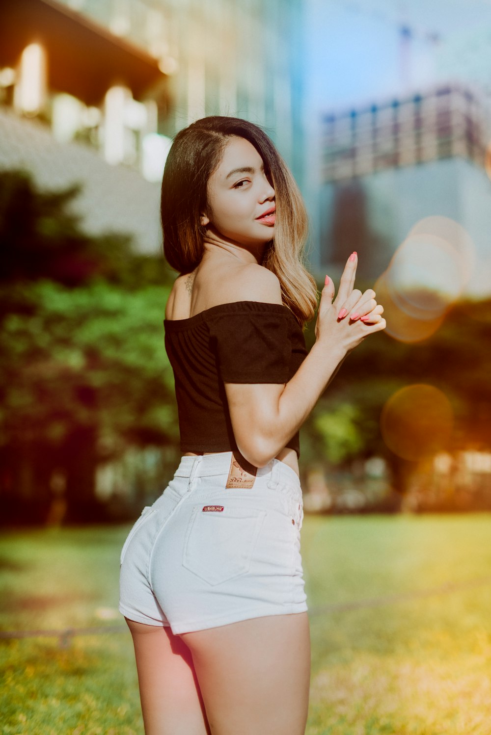 woman wearing black off-shoulder top and white short-shorts