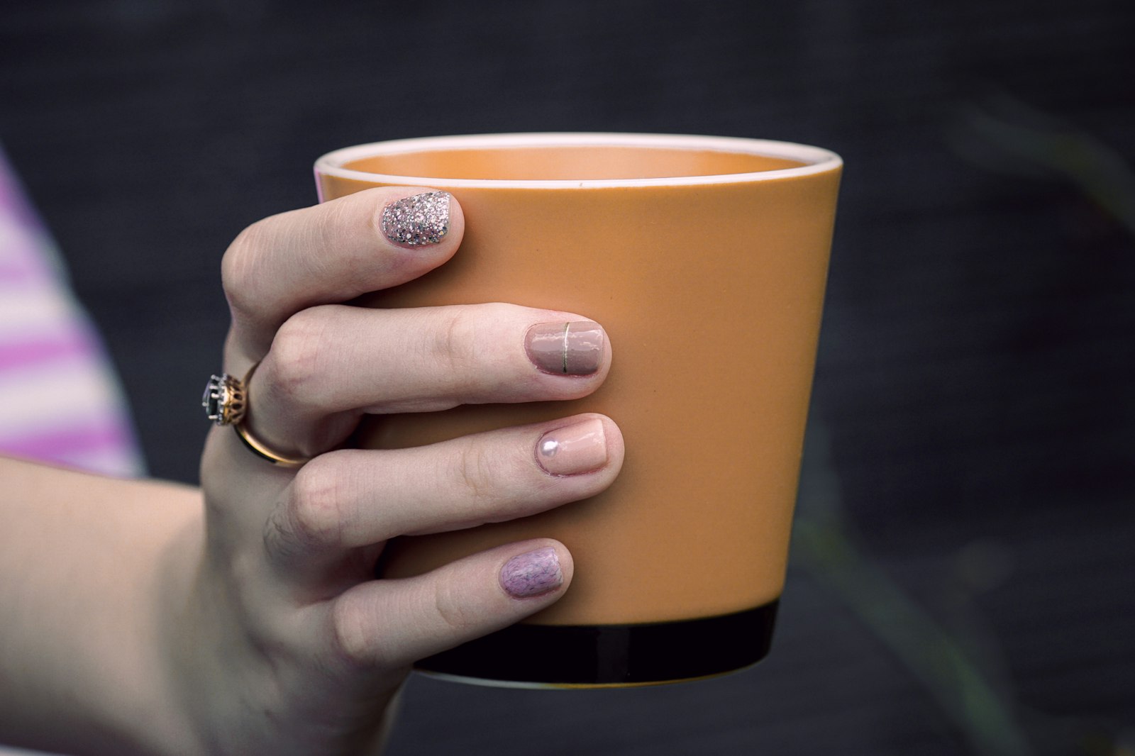 Sony a6000 + Sony FE 90mm F2.8 Macro G OSS sample photo. Person holding orange cup photography
