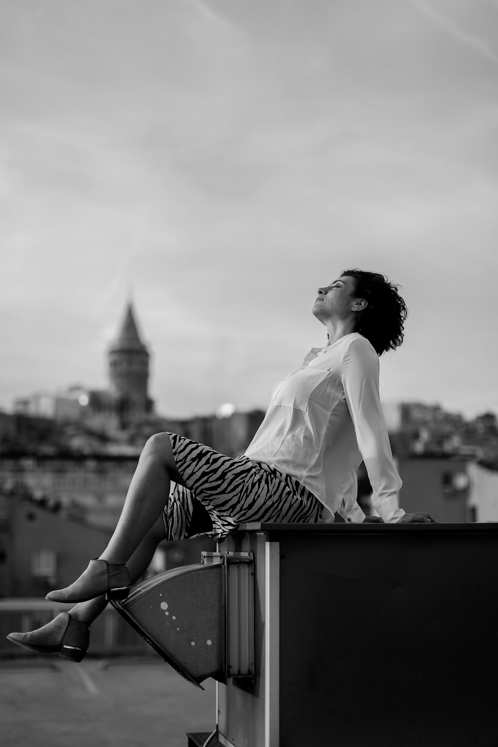 gray-scale photo of woman sitting