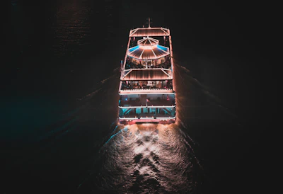 A luxury dinner cruise glowing with warm golden lights sailing along Goa’s coastline.