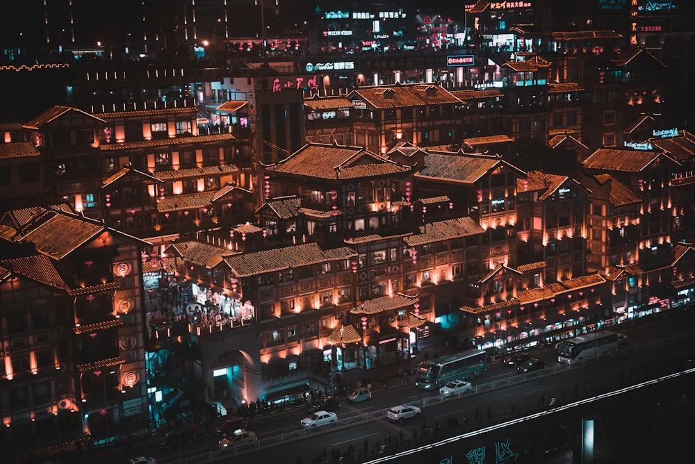 vehicles on road near buildings at night