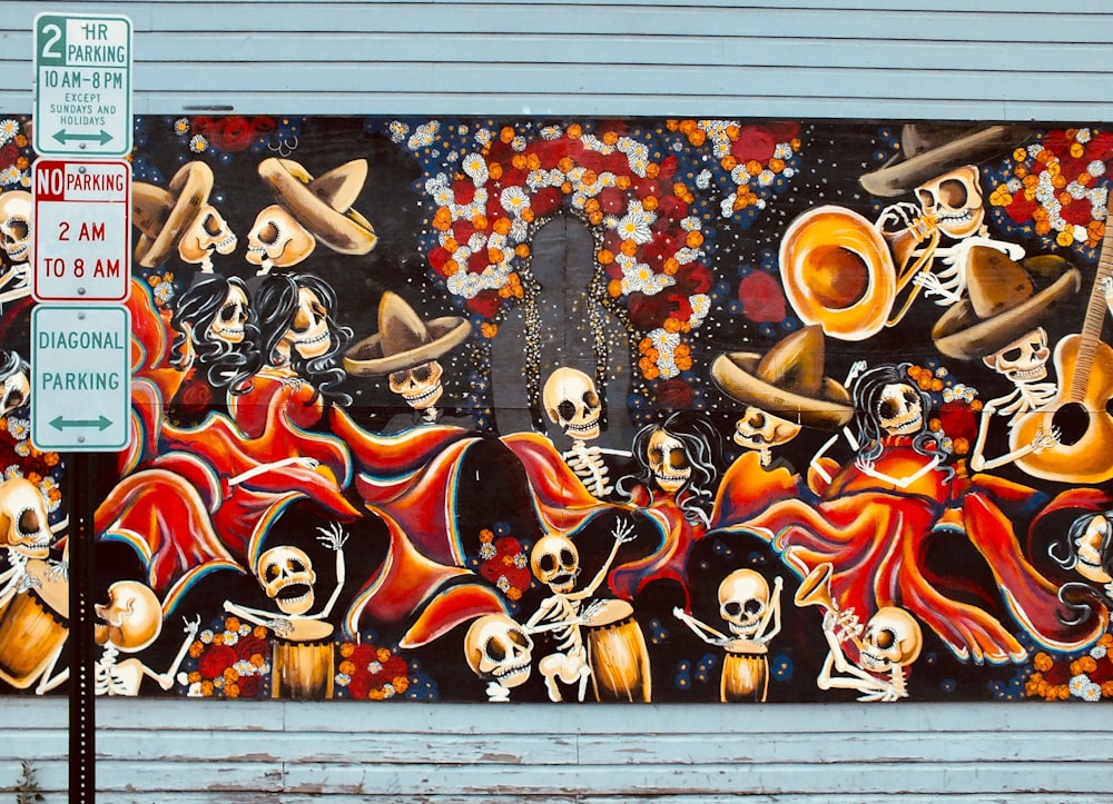 road sign in front of skeleton playing instruments graffiti