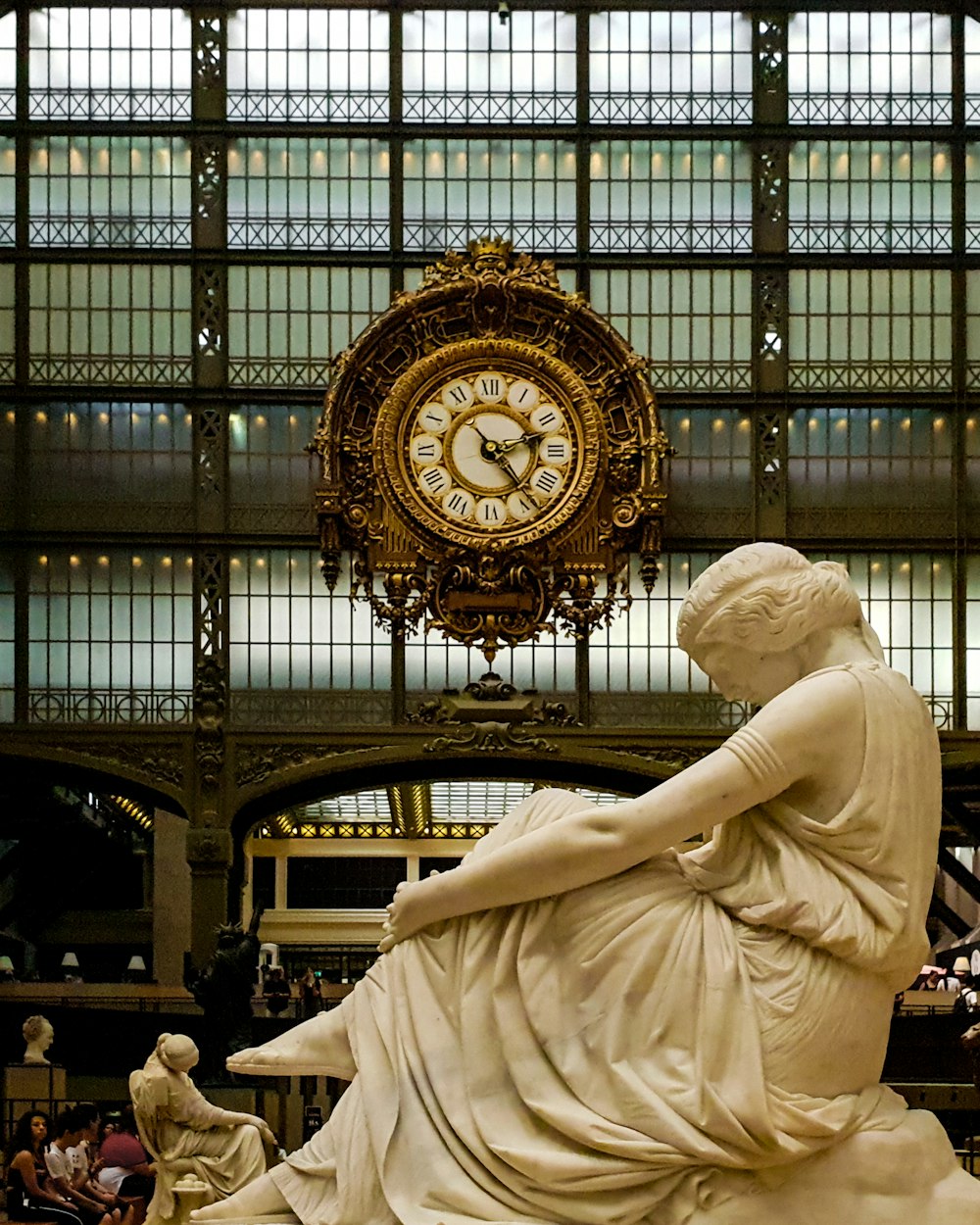 people sitting near Musee D'Orsay statue