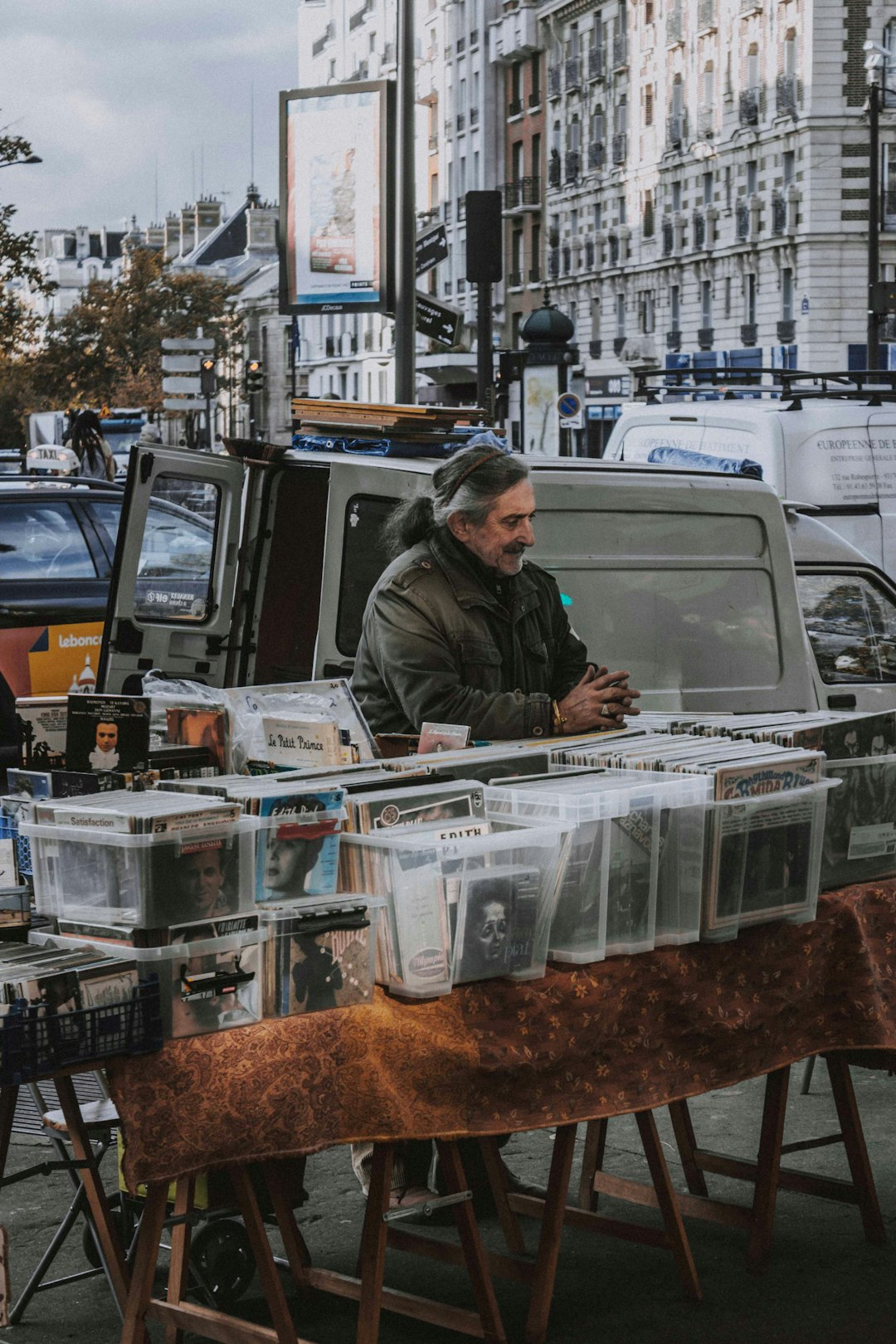 man wearing black jacket standing near the plastic container