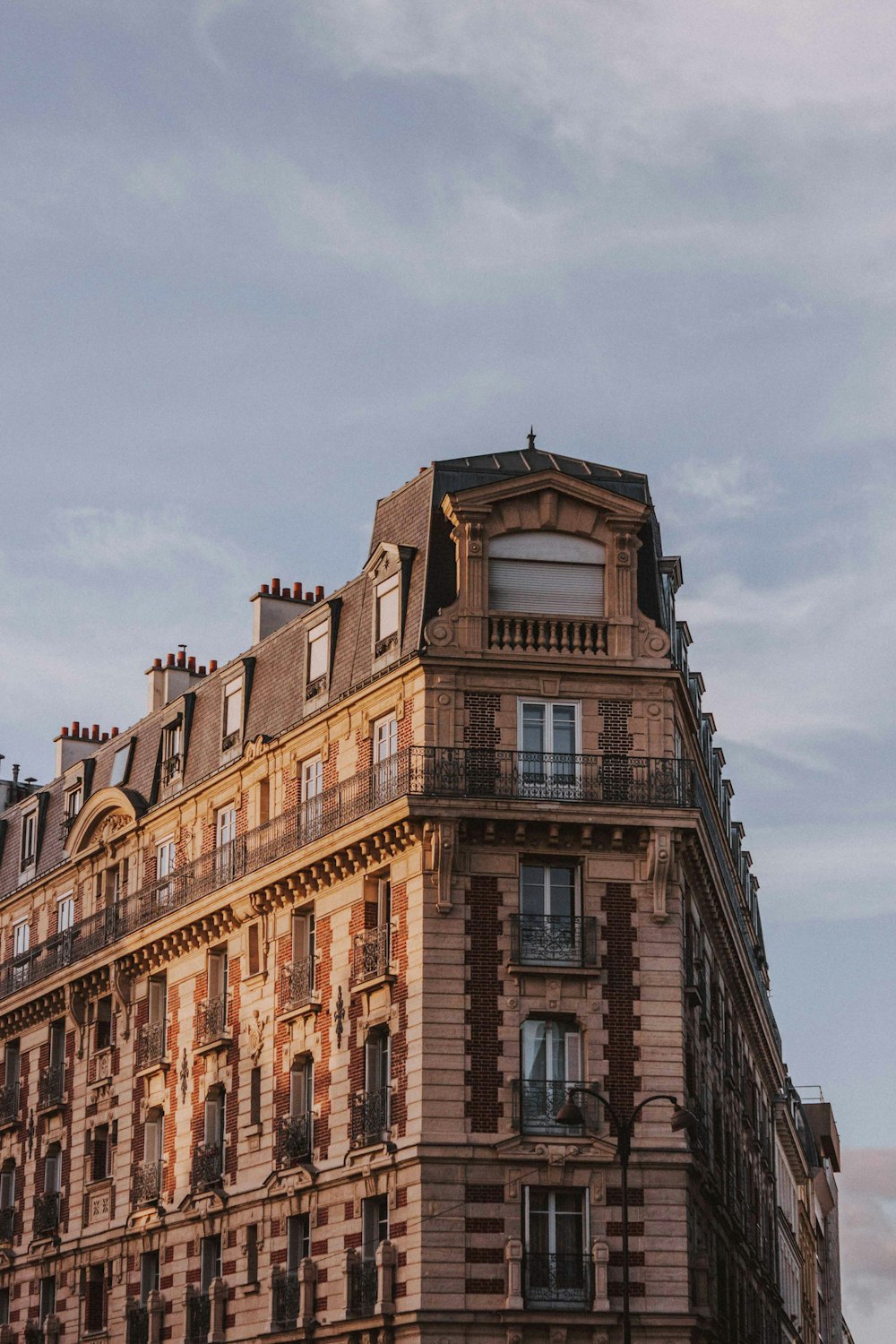 low-angle photo of brown building during cloudy day