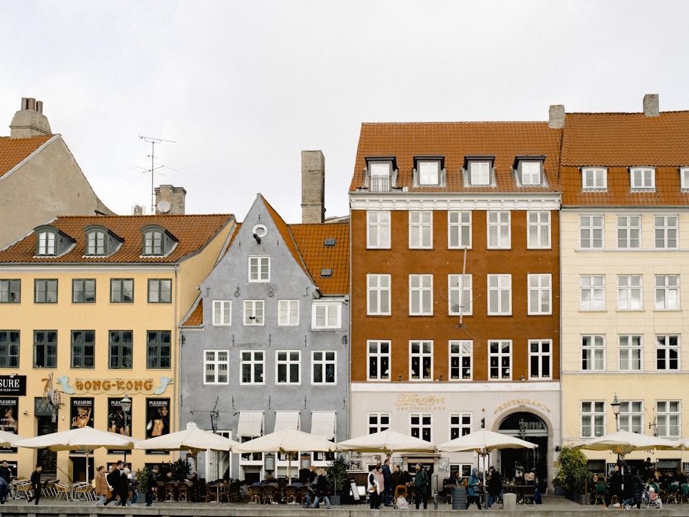 a row of buildings with umbrellas in front of them