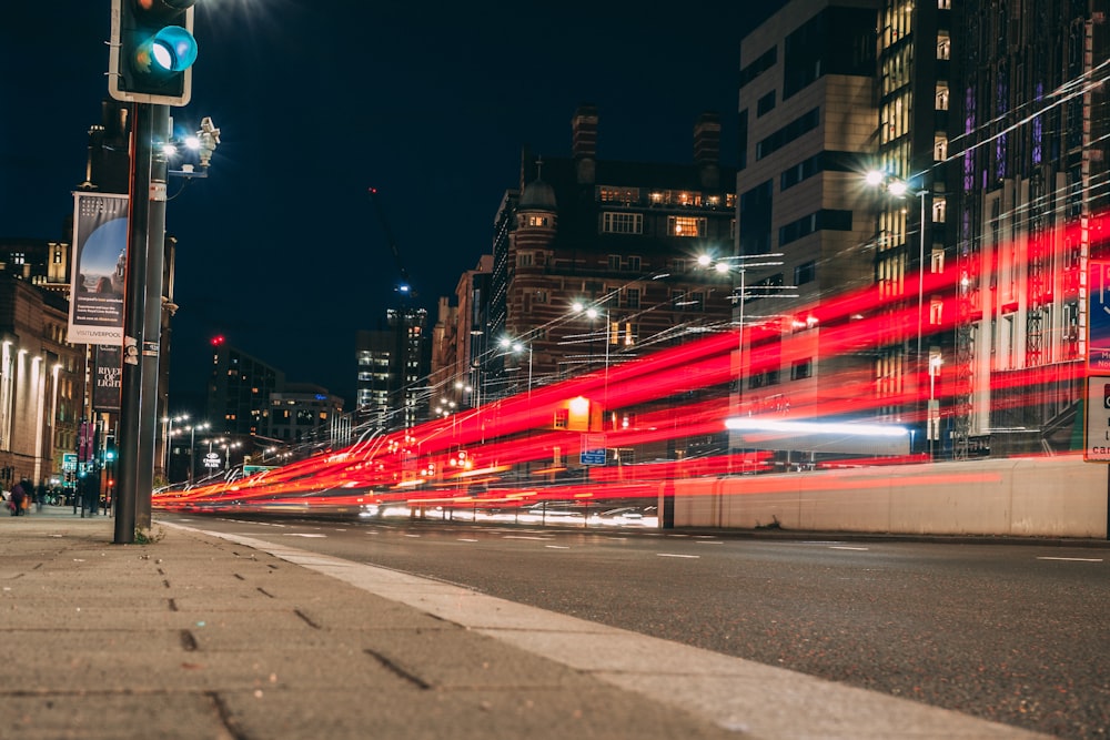 time-lapse photography of road viewing buildings during night time