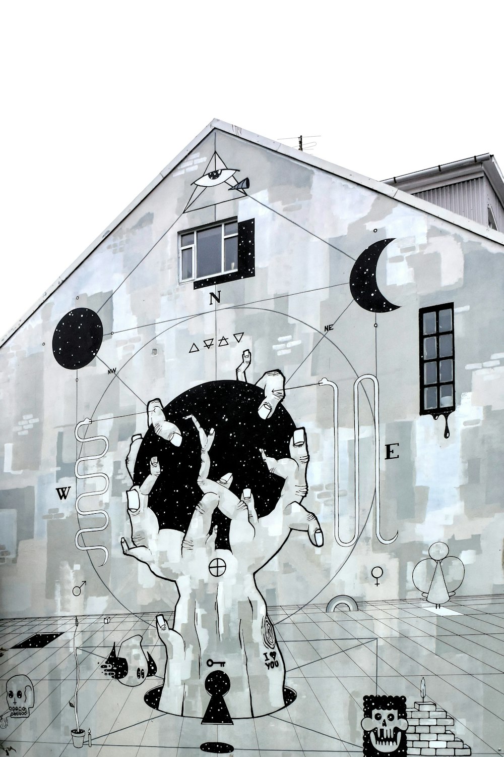 grayscale photography of concrete building with mural