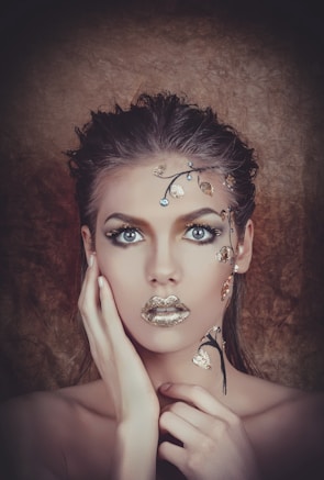 Portrait featuring intricate fantasy creature makeup with textured scales and vibrant colors.